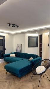 a living room with a blue couch and a table at Villa NOA in Bijeljina