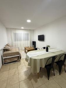 a room with a bed and a table and a couch at Amelie 4 in General Roca