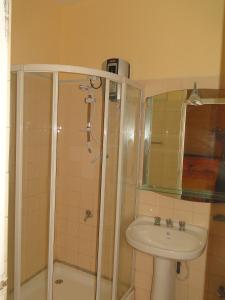 a bathroom with a shower and a sink at BRAMA Station Court  in Colombo