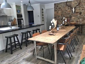 a kitchen and dining room with a wooden table and chairs at Silverwood House in Woodend