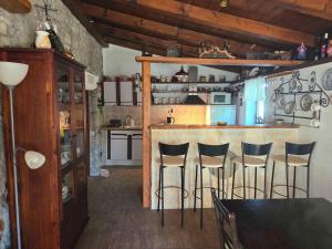 a kitchen with a bar with bar stools at Holiday home in Dobrinj - Insel Krk 27652 in Dobrinj