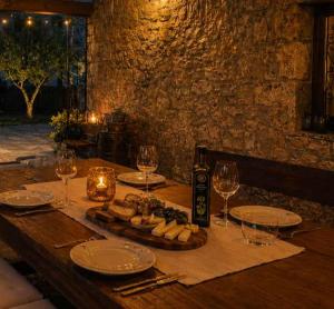 a wooden table with wine glasses and food on it at Holiday home in Dobrinj - Insel Krk 27652 in Dobrinj