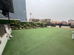 a balcony with a green carpeted floor on a building at Emmydon Hotel And Suites in Enugu