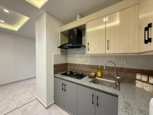 a kitchen with a sink and a counter top at 2 BHK Stayloom 218 in Rawalpindi