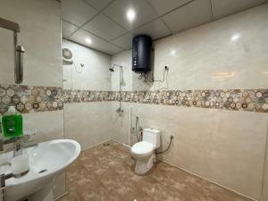 a bathroom with a toilet and a sink at 2 BHK Stayloom 218 in Rawalpindi +11 photos