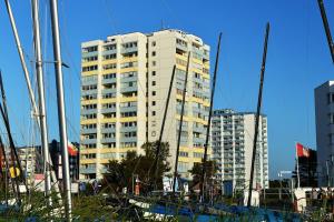 a tall white building with trees in front of it at Strandhochhaus SHC2 in Cuxhaven