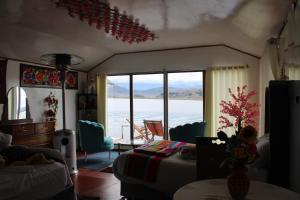 a living room with a view of the water at Titicaca Wara wara Lodge in Puno +6 photos