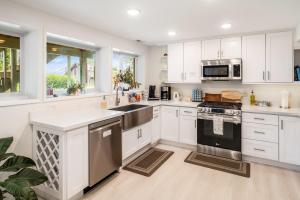 a kitchen with white cabinets and stainless steel appliances at Seasons at Leschi Hillsides in Seattle