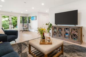 a living room with a tv and a couch and a table at Seasons at Leschi Hillsides in Seattle