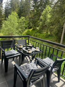 a table and chairs on a balcony with a view at Monteluce Apartment Vlašić in Šišava