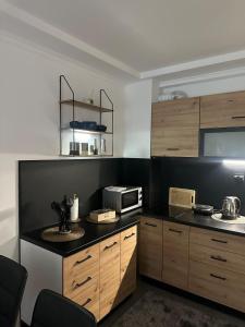 a kitchen with a sink and a microwave at Monteluce Apartment Vlašić in Šišava
