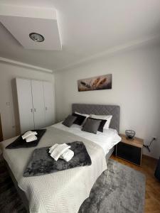 a bedroom with a large bed with towels on it at Monteluce Apartment Vlašić in Šišava