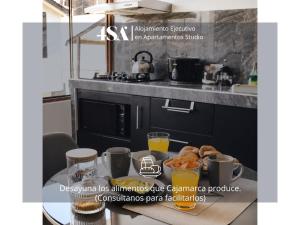 a magazine advertisement for a kitchen with a table with food at 4StudioAparts RC 04 in Cajamarca