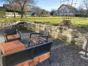 a group of benches and a stone wall at Maisonnette Hauts d'Evian in Larringes