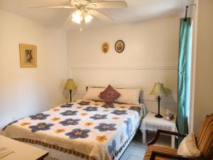 a bedroom with a bed and a ceiling fan at Near Cavendish Beach-2 in Stanley Bridge +48 photos