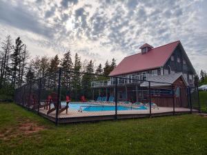 a large building with a pool in front of a house at Near Cavendish Beach-2 in Stanley Bridge