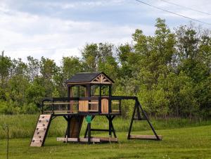 a playground with a small house on top of it at Near Cavendish Beach-2 in Stanley Bridge