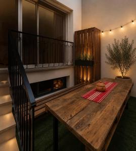a wooden table in a room with a fireplace at Blueyes in Tunis +1 photo