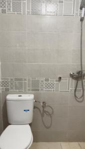 a bathroom with a toilet and a shower at DAR LAHCEN - Terrace & Mountain View in Ourika