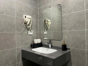 a bathroom with a sink and a mirror at Valoria Premium Hanoi Hotel and Travel in Hanoi +57 photos