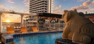 a statue of a bear next to a pool on a cruise ship at Whitehouse Condotel in Pattaya