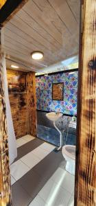a bathroom with a toilet and a sink at Sameer Mountain View Retreat in Tanah Rata