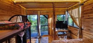 a bedroom with a bunk bed and a television in a cabin at Sameer Mountain View Retreat in Tanah Rata