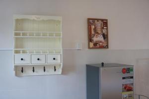 a kitchen with a stove and a refrigerator at Tran Phu Riverside House in Can Tho