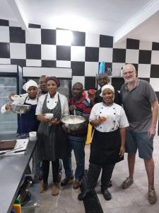a group of people in a kitchen posing for a picture at Shiri Beach Resort in Zanzibar City +57 photos