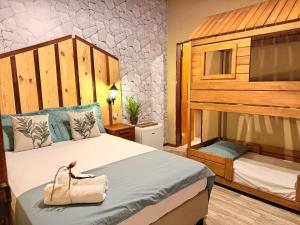 a bedroom with a bunk bed with a purse on it at Rancho PJ - Presidente Juscelino-MA in Morros +11 photos