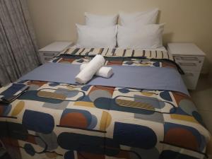 a bed with a roll of toilet paper on it at 3D Power guest house in Durban