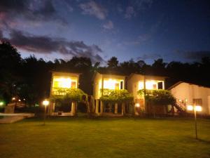 a house with lights in the yard at night at Rancho PJ - Presidente Juscelino-MA in Morros