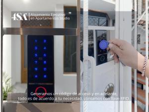 a hand opening a door with a blue door knob at 4StudioAparts RC 04 in Cajamarca
