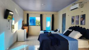 a bedroom with two beds in a room at Mini Apartamentos na entrada de Tutóia in Tutóia