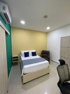 a bedroom with a bed and a chair in it at Muramar 43 Hotel Cartagena in Cartagena de Indias +73 photos