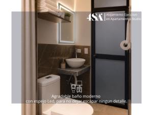 a bathroom with a toilet and a sink at 4StudioAparts RC 04 in Cajamarca +13 photos