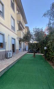 a green lawn in front of a building at Private Parking & Garden -Luxury B&B-700mt Tower in Pisa