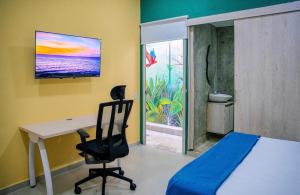 a bedroom with a desk and a chair and a window at Muramar 43 Hotel Cartagena in Cartagena de Indias