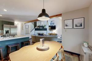 a kitchen and a dining room with a table and a kitchen at Cozy Condo In The Woods in Lincoln +39 photos