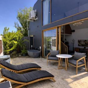 a patio with two chairs and a table at Hobart Retreats - Sanctuary and Haven in Hobart