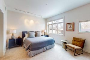 a bedroom with a bed and a chair and a window at Precious Pearl in Jackson