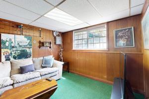 a living room with a couch and a table at Gloucester Getaway in Gloucester