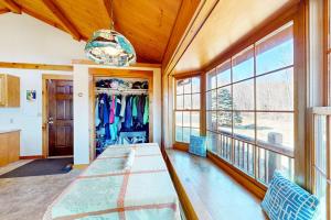 a dining room with a table and a large window at Summit Solitude in Franconia