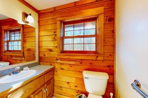 a bathroom with a toilet and a sink at Summit Solitude in Franconia +82 photos