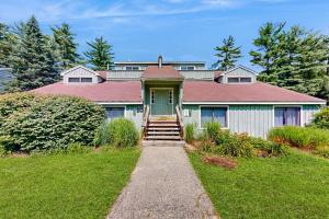 a house with a green door and a grass yard at Four Seasons Retreat in Bartlett