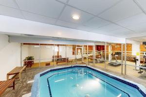 a large swimming pool in a large room with at Four Seasons Retreat in Bartlett