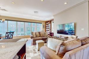 a large living room with couches and a tv at Gloucester Harbor Hideaway in Gloucester