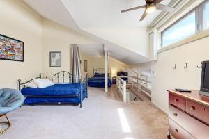 a bedroom with two beds and a ceiling fan at Four Seasons Retreat in Bartlett +37 photos