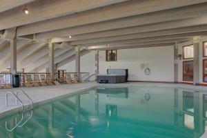 a swimming pool with chairs in a building at Hodgman Getaway in Campton