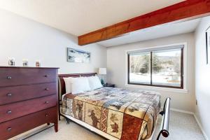 a bedroom with a bed and a dresser and a window at 6B The Seasons in Bartlett +43 photos
